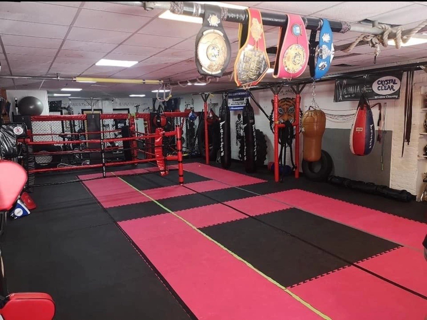 Coach holding pads for a fighter at Valhalla Martial Arts Weymouth