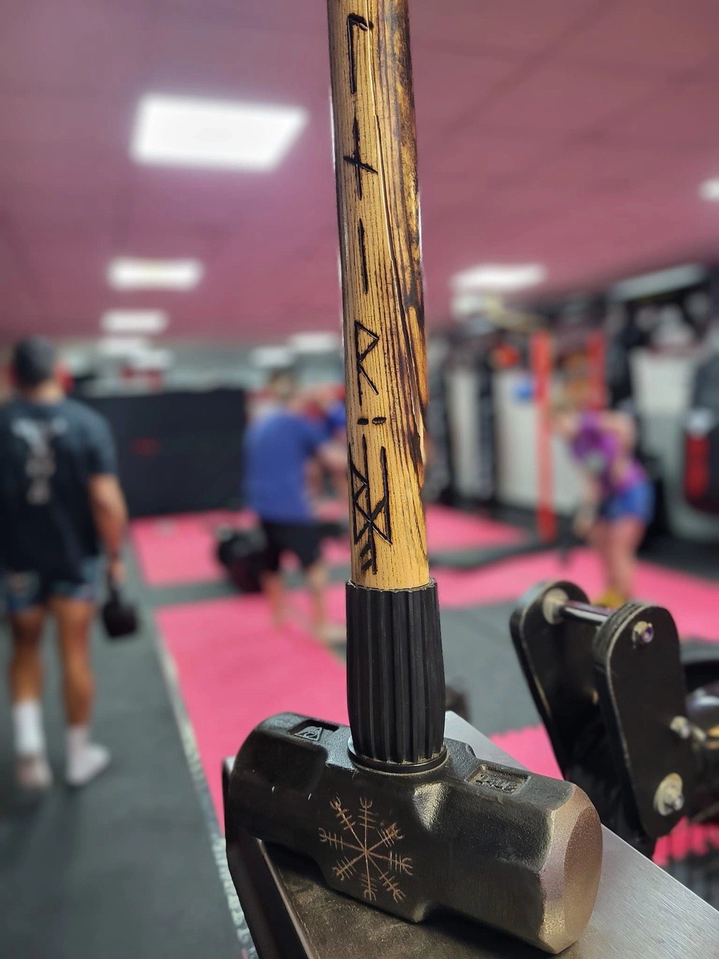 Coach holding pads for a fighter at Valhalla Martial Arts Weymouth