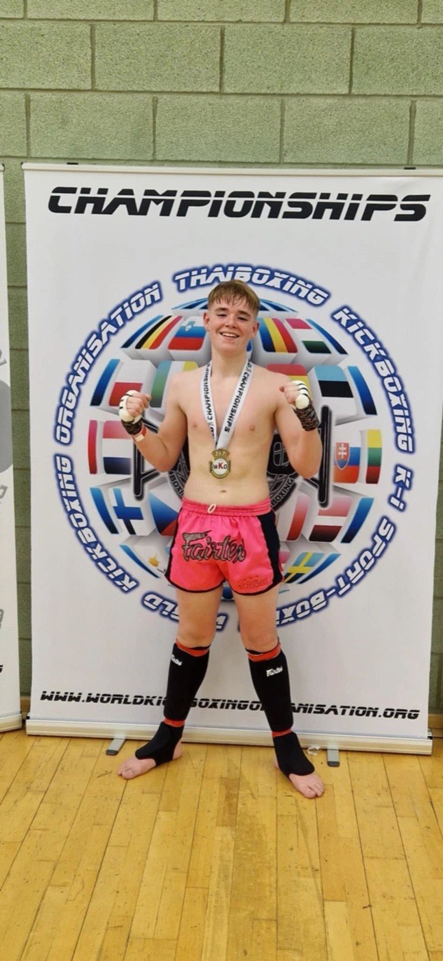 Junior fighter with a championship medal at Valhalla Martial Arts