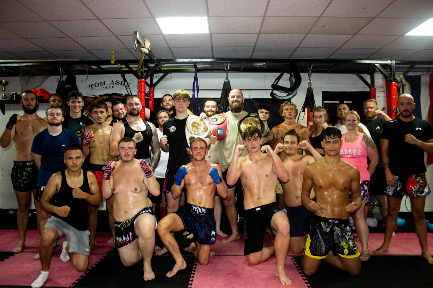 Valhalla Martial Arts fighters and coaches with championship belts