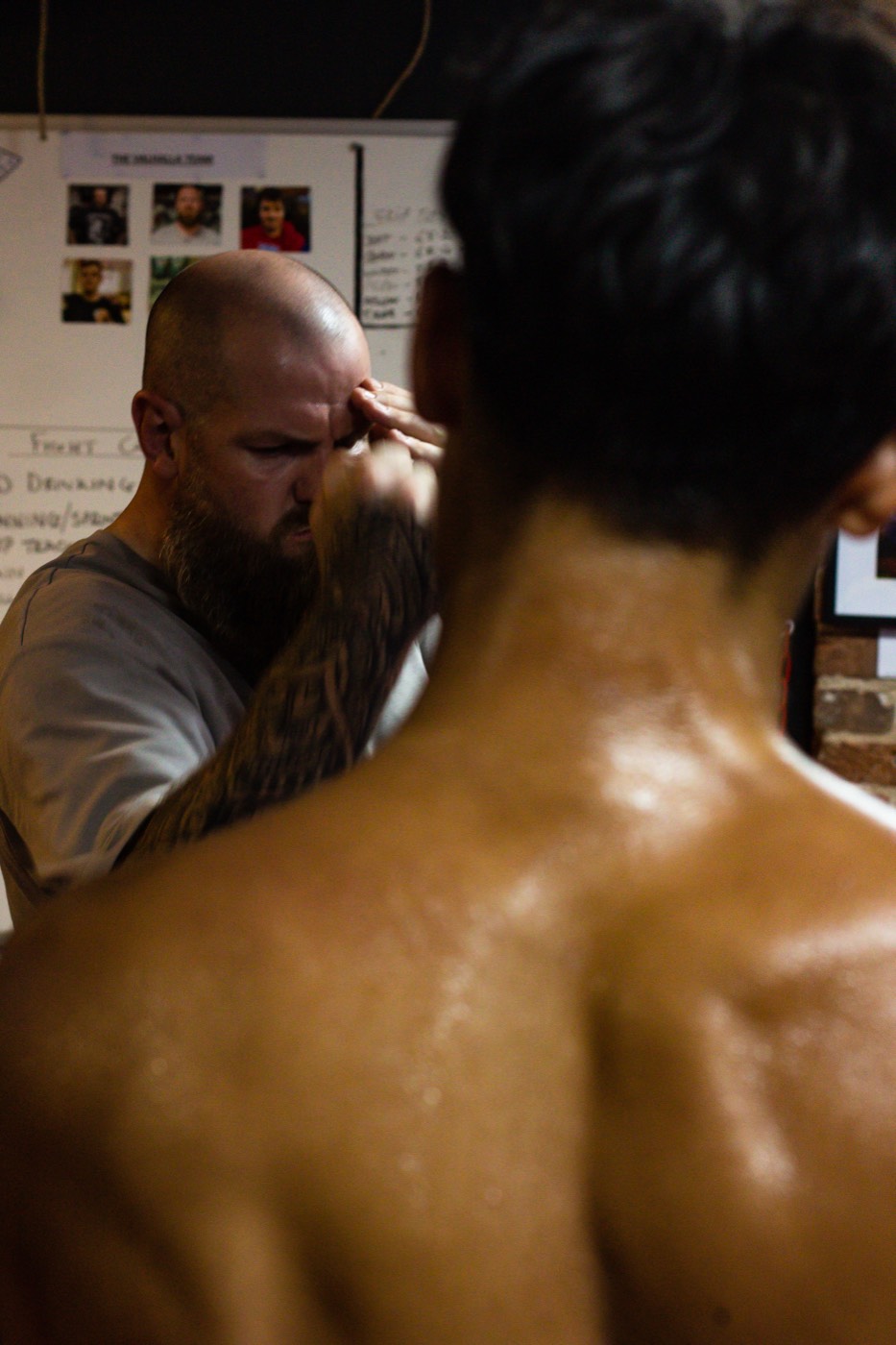 A Valhalla Martial Arts coach checking a fighter before a bout